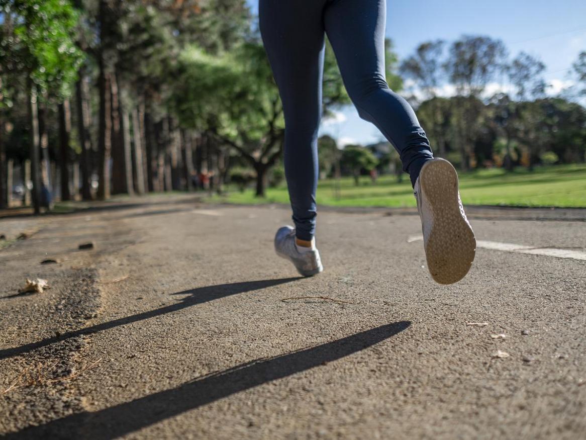 Legs of person running on a track