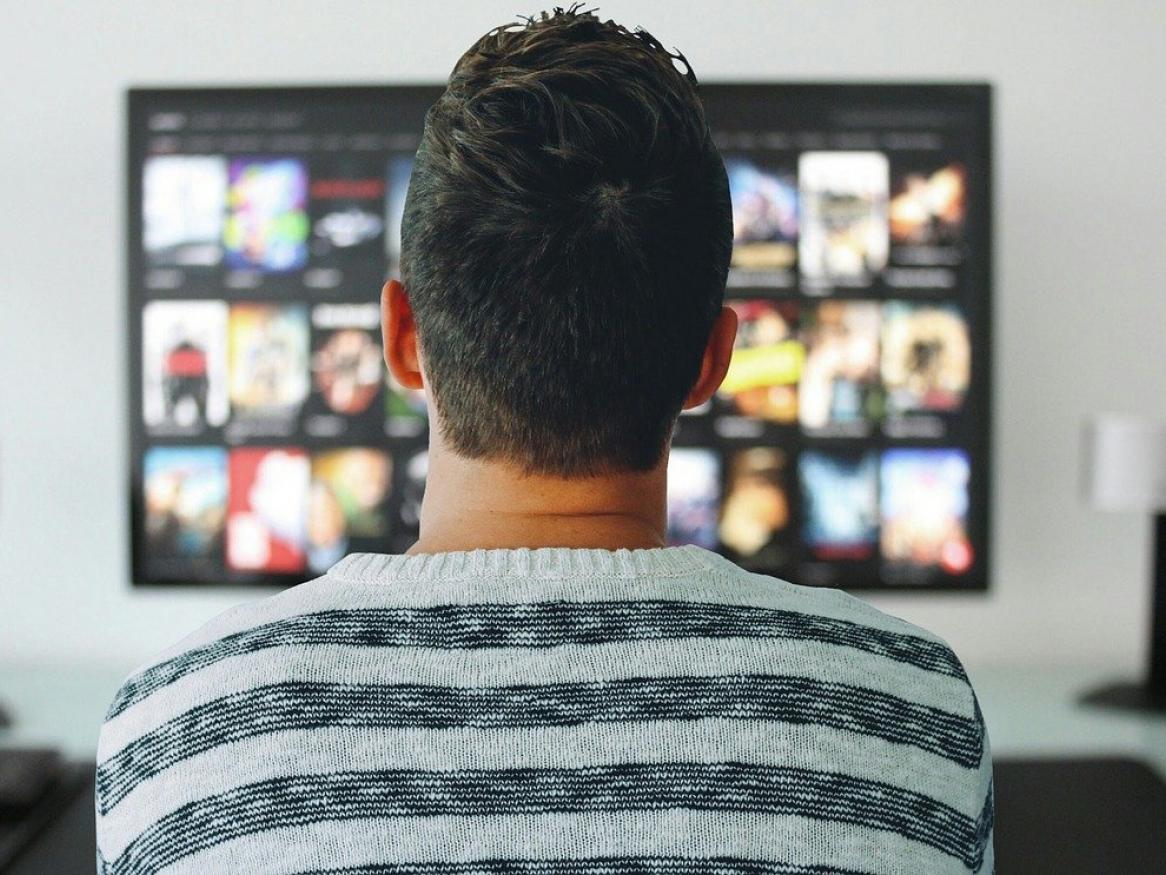 A person is browsing Netflix on their television.