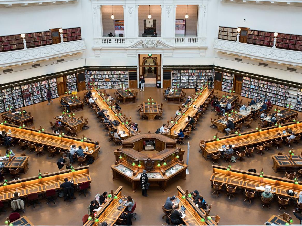 A bird's eye view of the State Library of Victoria, showing people studying at desks.