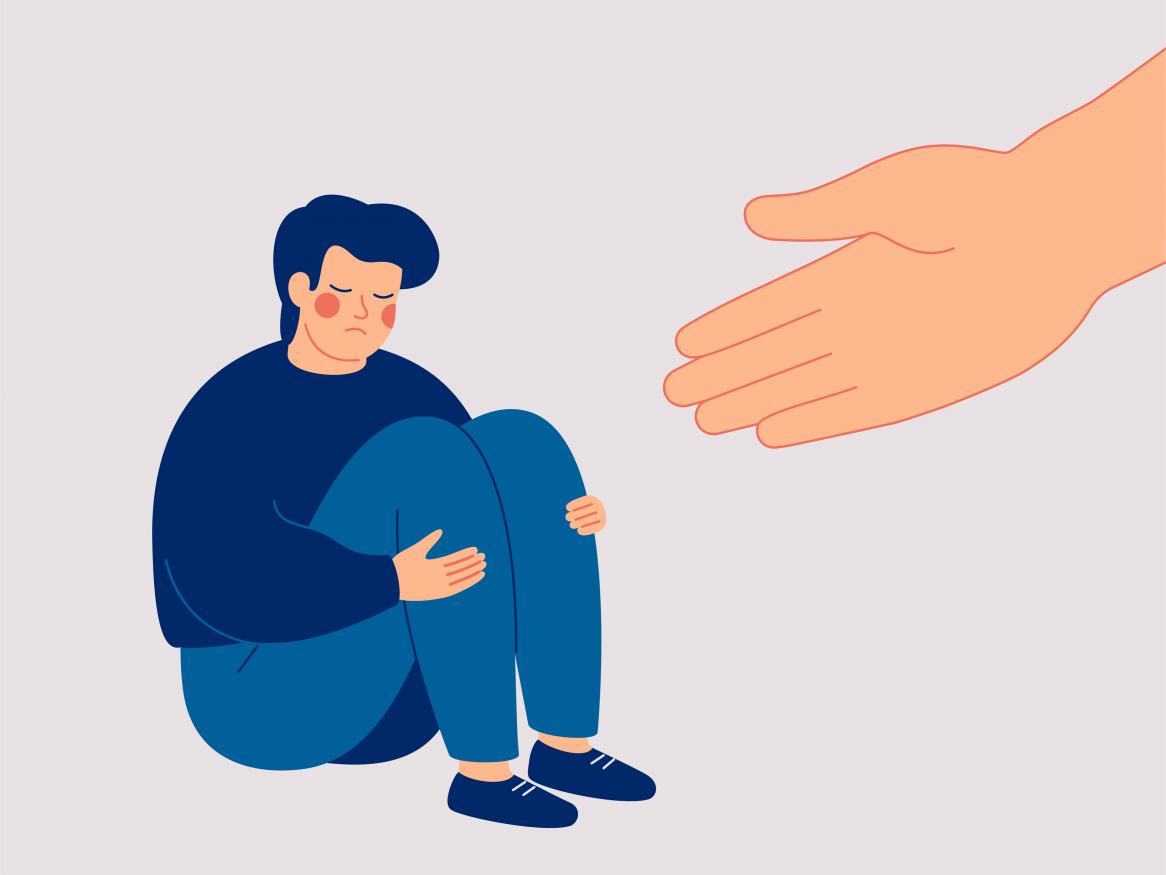 Someone sitting, looking sad with a large hand offering help