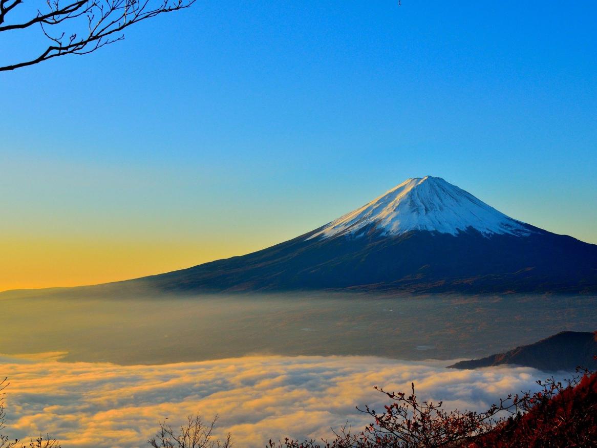 A distant photograph of mount Fuji at sunset.