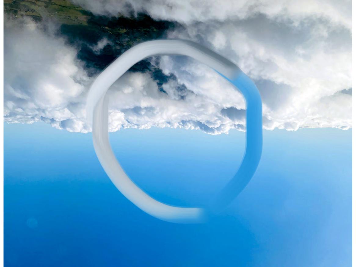 Photo of blue sky with low lying clouds covering the ground below