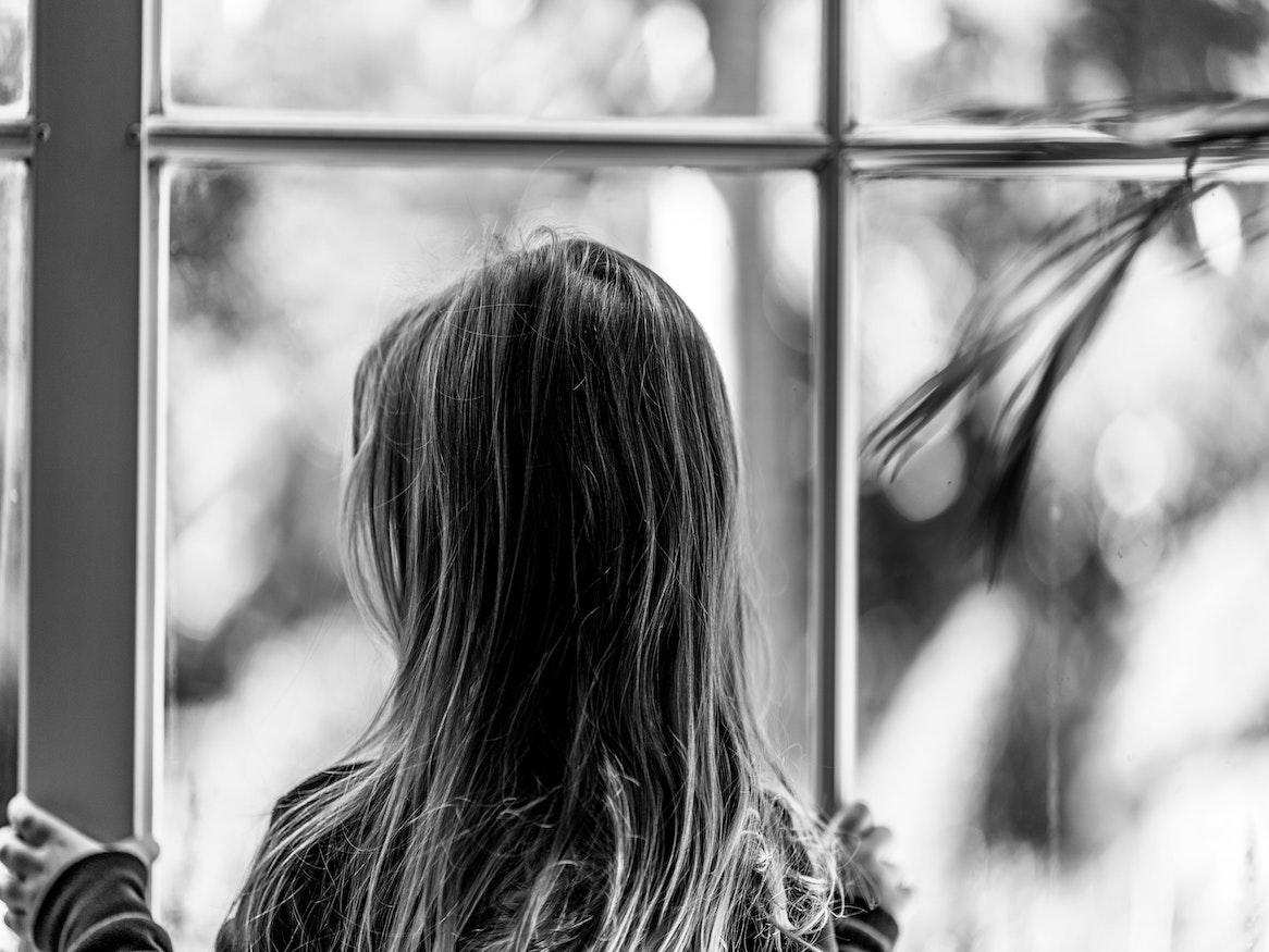 Girl looking out window