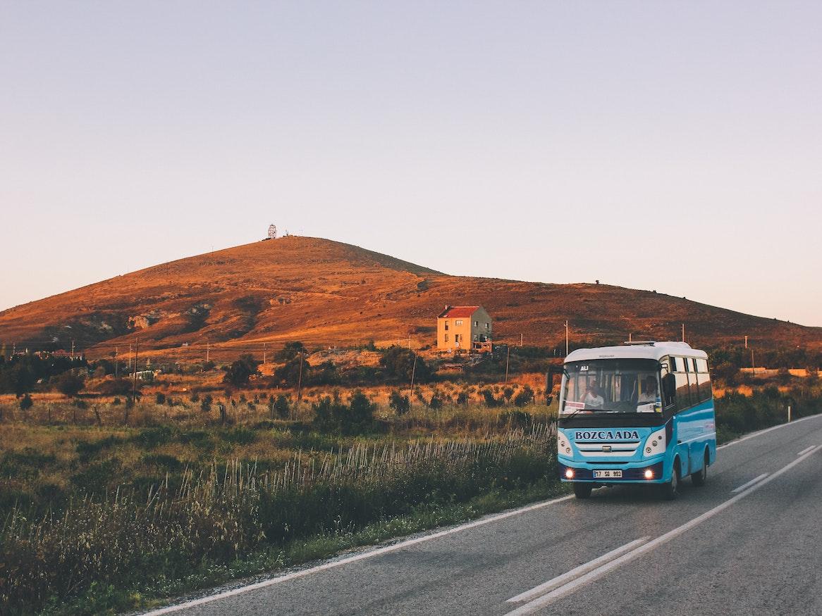 A bus driving in the country side.
