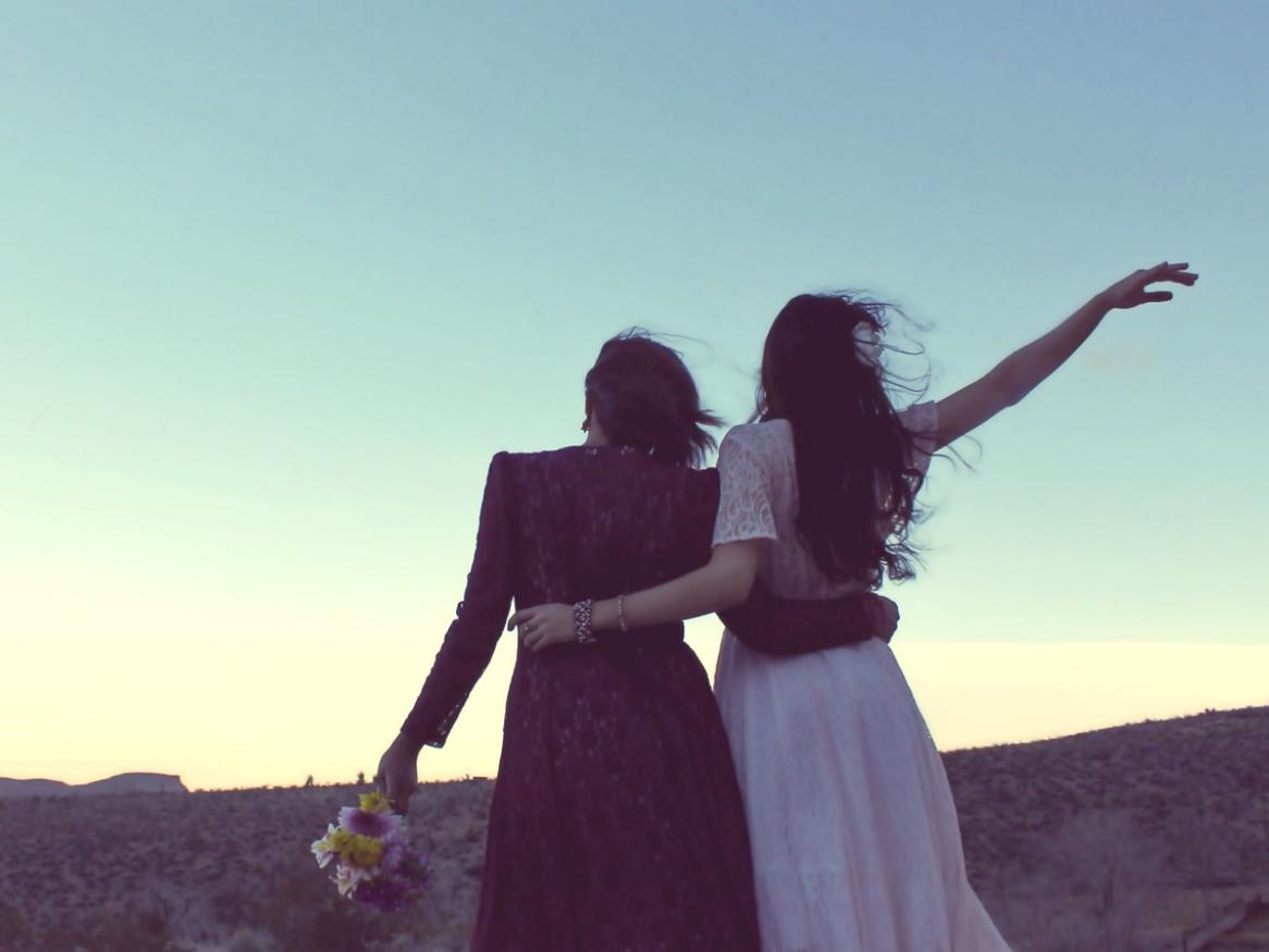 Two women looking at a sunset.