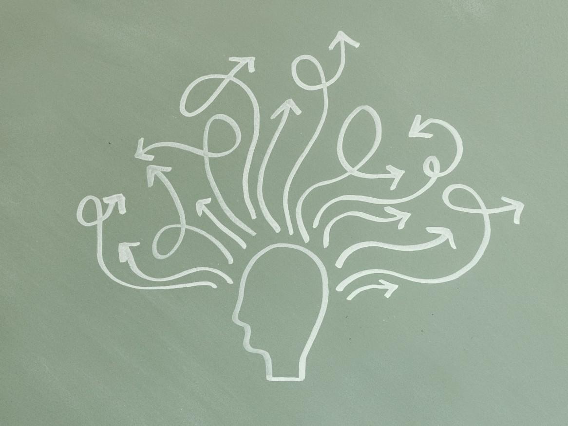 Chalkboard illustration of a person with squiggly arrows coming out of their head
