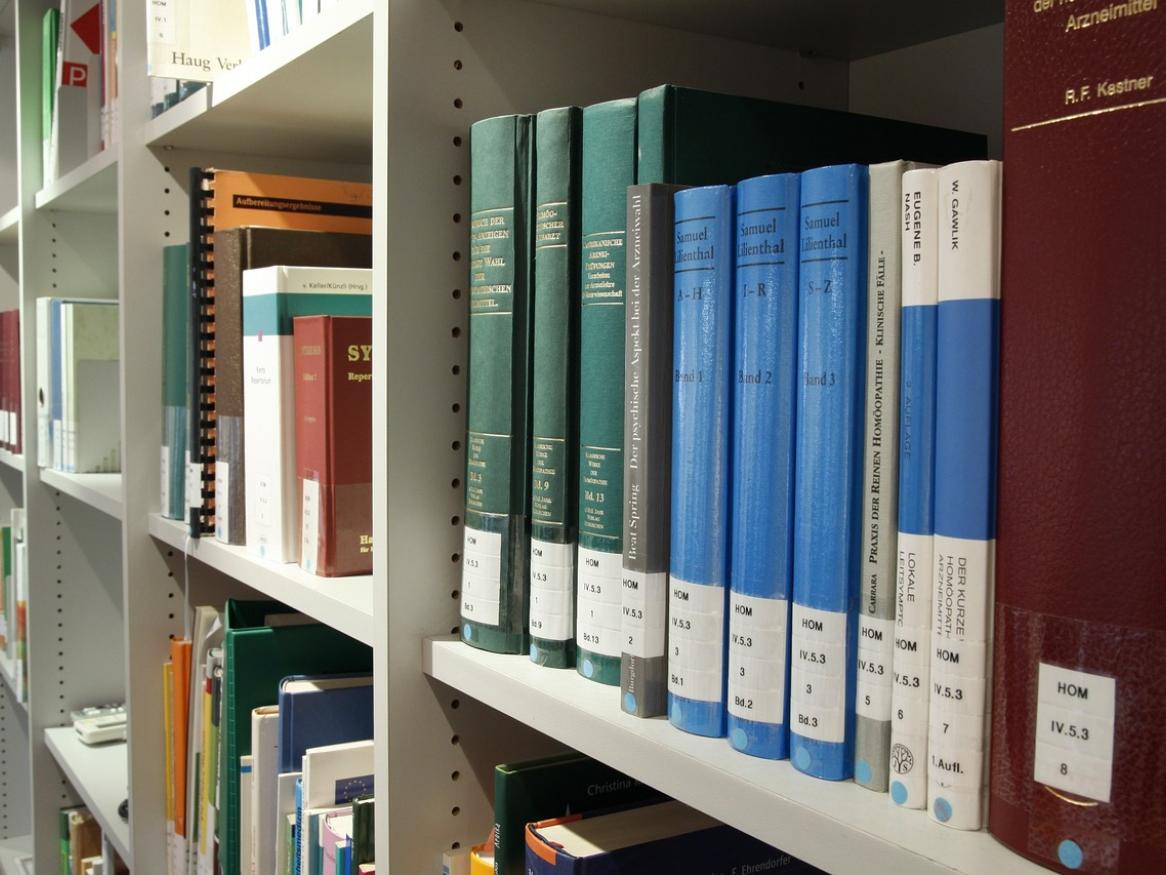 A close up of academic books on a shelf. 