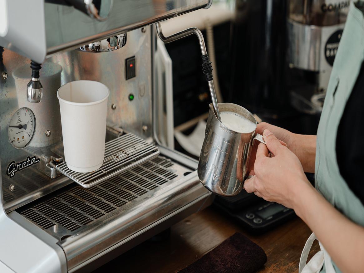 Coffee machine pouring milk