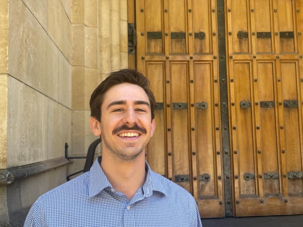 Chalton Gunn standing in front of Bonython Hall