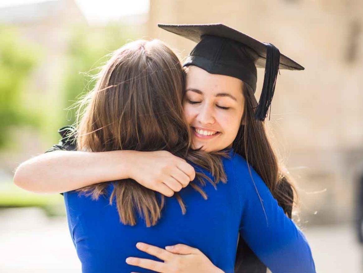 Parent and student embracing at graduation