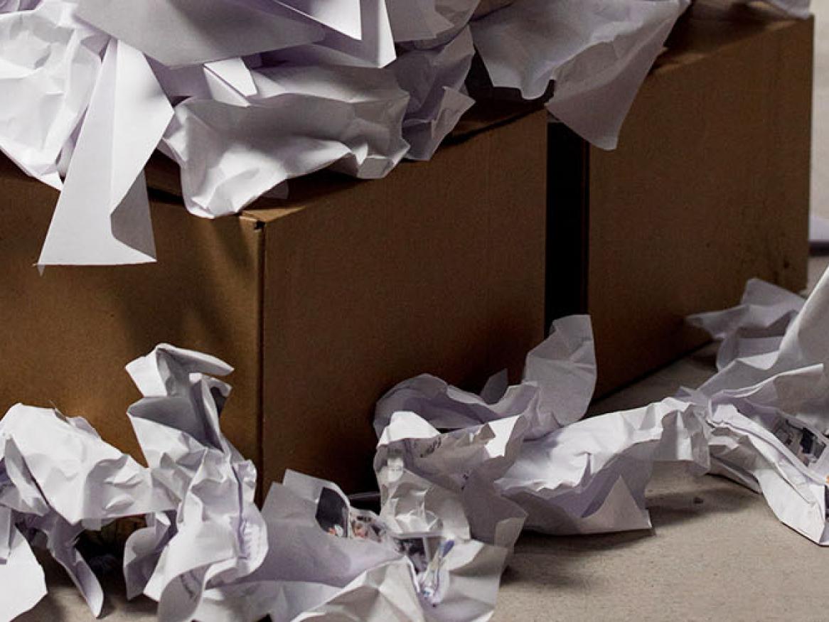 Scrunched up paper in a cardboard box