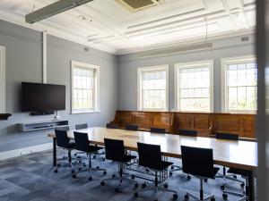 Clubs board room with long table, seating and screen