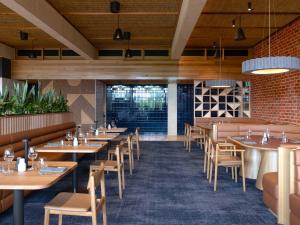 Taikunthi restaurant with set tables and feature wall