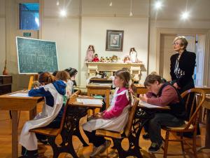Children's University students participating in an 1892 recreated history experience in the School Room