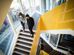 High quality, professional on-brand image of students walking down stairs.